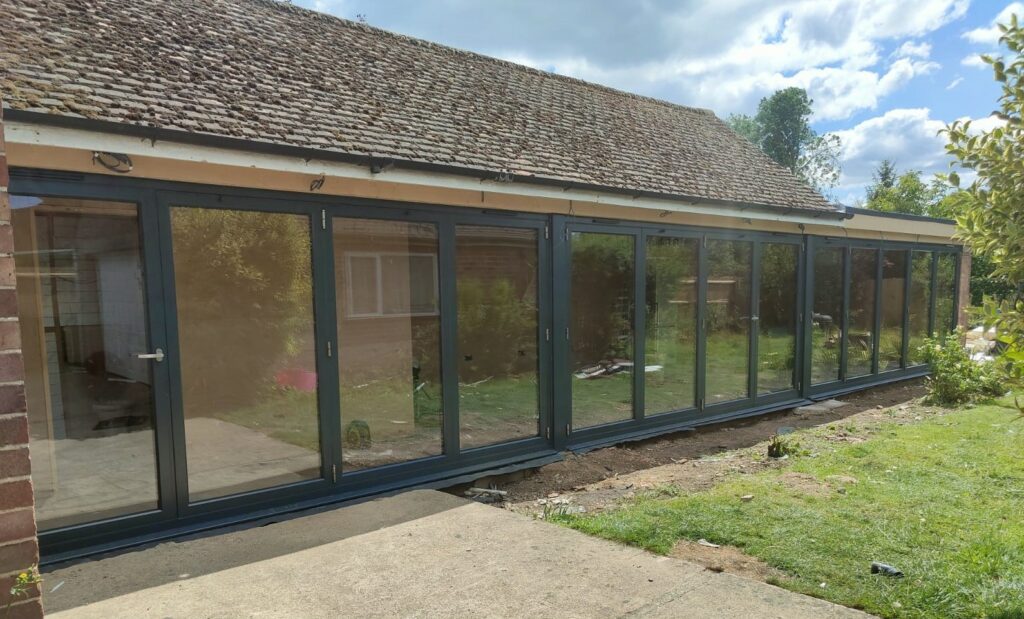 Origin bifold doors in Peterborough to a large extension in a black colour
