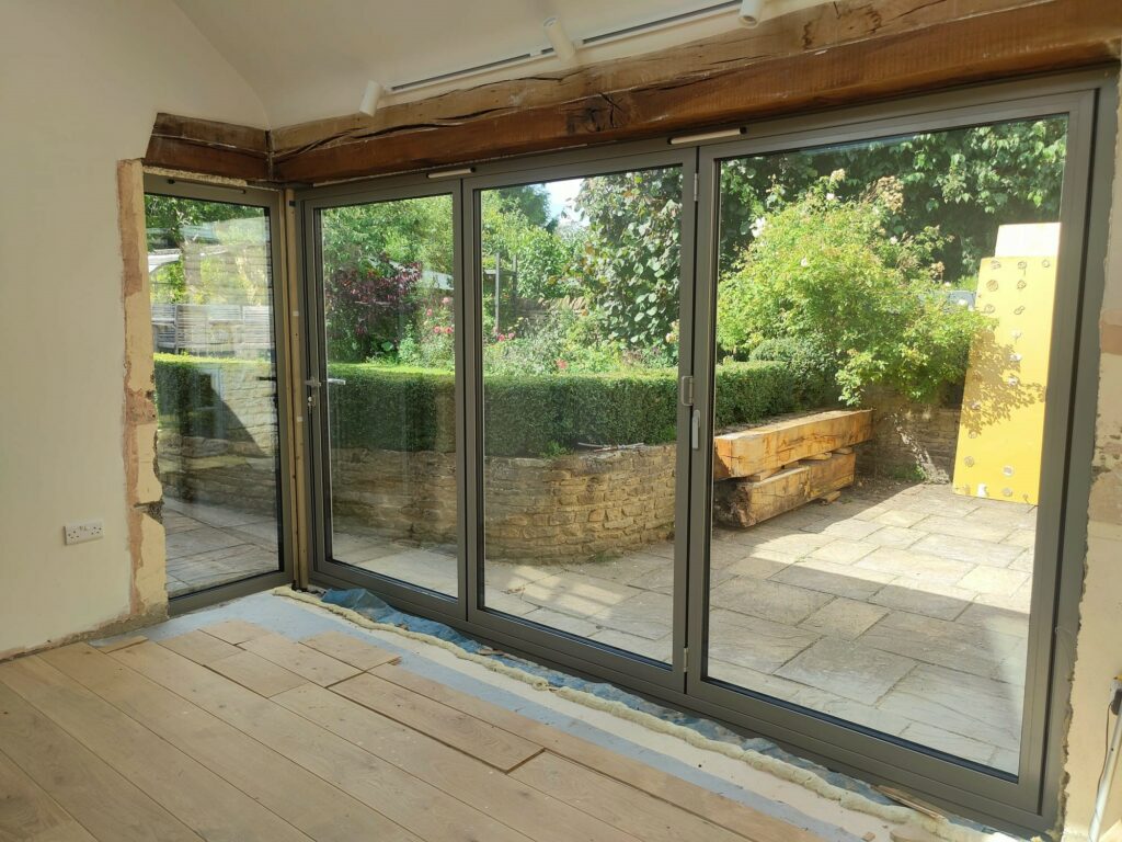 Schuco bifold doors in a green colour to a new extension