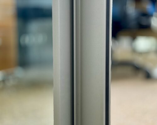 Cortizo sliding doors with standard opening design. Close up. 